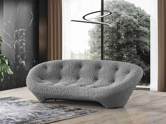 Canapé design contemporain à l’aspect sculptural avec revêtement texturé, forme arrondie et assise profonde, style moderne et confortable