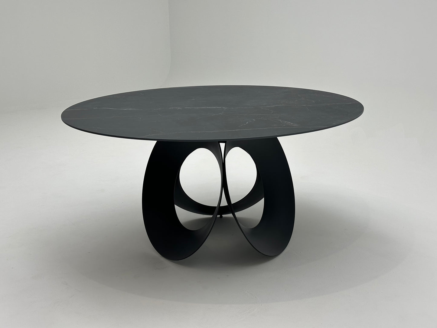 Table à manger ronde en céramique et métal traité, offrant un design élégant et moderne pour une salle à manger raffinée et durable