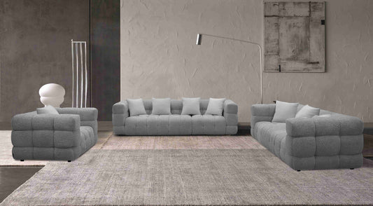 Ensemble de salon contemporain avec canapés matelassés à forme cubique, revêtement texturé, assise généreuse et style moderne dans un intérieur design