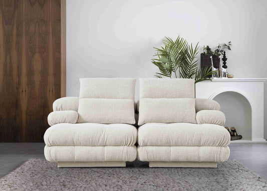 Canapé moderne deux places au design matelassé et formes volumineuses