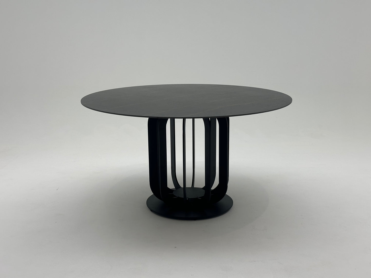 Table à manger ronde en céramique et métal traité, offrant un design élégant et moderne pour une salle à manger raffinée et durable