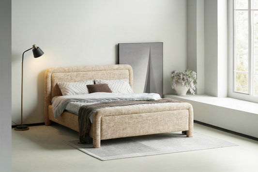 Tête de lit rembourrée au design moderne et arrondi, idéale pour une chambre élégante et chaleureuse.