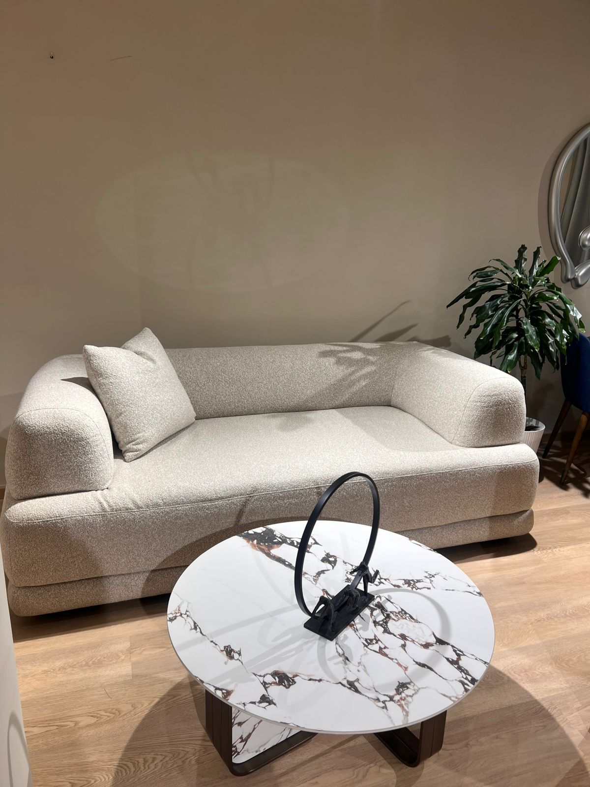 Canapé design moderne en tissu bouclé beige, aux formes arrondies et minimalistes
