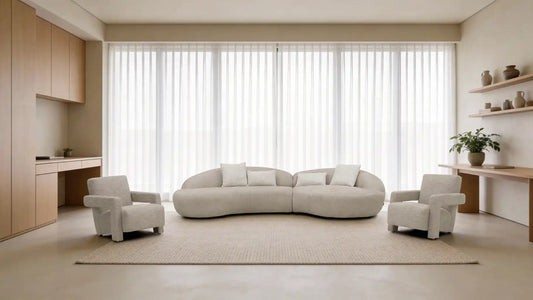 Canapé design arrondi en tissu beige avec fauteuils assortis dans un salon moderne lumineux