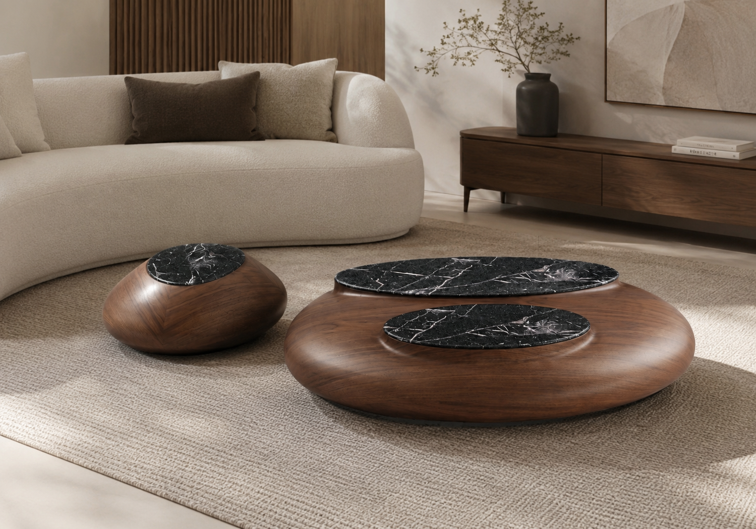 Table basse ovale en bois avec plateau en marbre noir veiné blanc, accompagnée d’une petite table d’appoint assortie, dans un salon moderne et élégant.