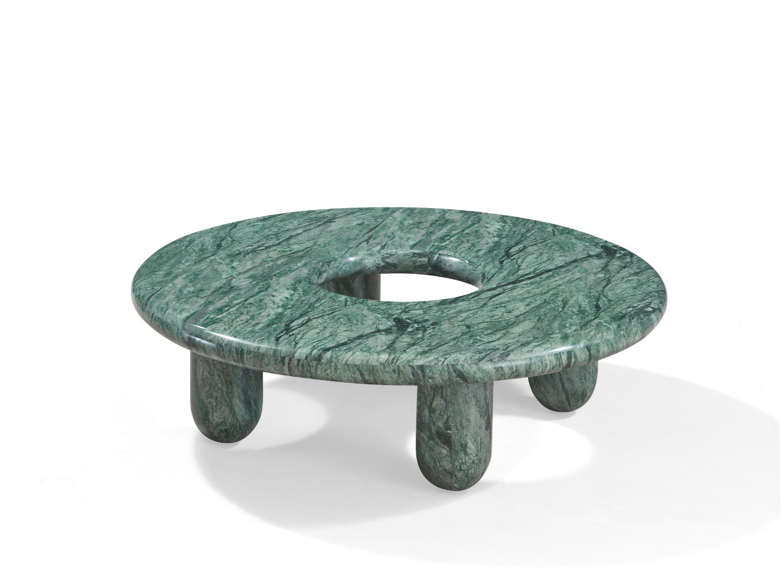 Table basse Nevada en pierre naturelle avec plateau circulaire et ouverture centrale, design contemporain et pieds arrondis.